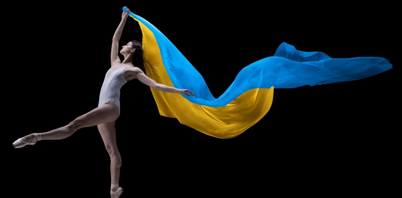 ballerina dancing with cloth painted in blue and yellow colors of Ukraine flag