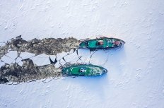 Two icebreakers breaking ice on Vistula river, Poland, 2020-02-18, aerial view