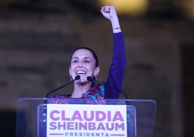 Claudia Sheinbaum with arm raised