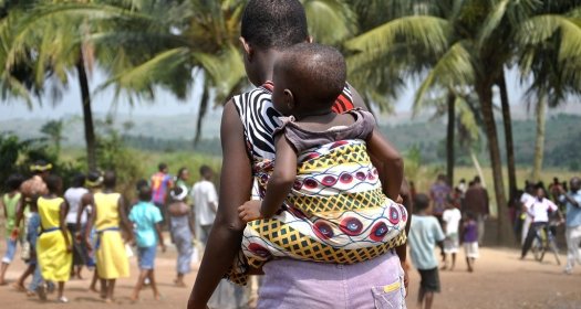 Ghana mother and child visit water pump provided by USAID