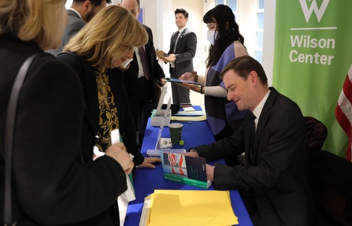 Ambassador David Hale signing books