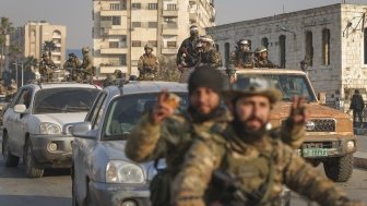 Syrian opposition fighters ride along the streets in the aftermath of the opposition's takeover of Hama, Syria, Friday, Dec. 6, 2024. 