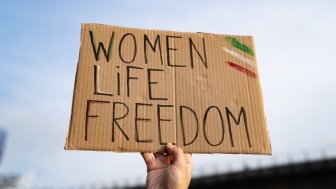 Protest sign reading "Women, Life, Freedom"