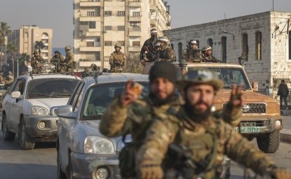 Syrian opposition fighters ride along the streets in the aftermath of the opposition's takeover of Hama, Syria, Friday, Dec. 6, 2024. 