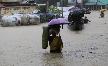 Women walking through flooded street, Bangladesh