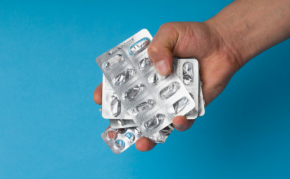 Hand holding empty pill blisters