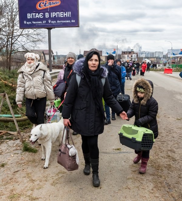 IRPIN, UKRAINE - Mar. 05, 2022: War in Ukraine. Women, old people and children evacuated from Irpin town was transferd to Kyiv by Kyiv territorial defense battalion. War refugees in Ukrain