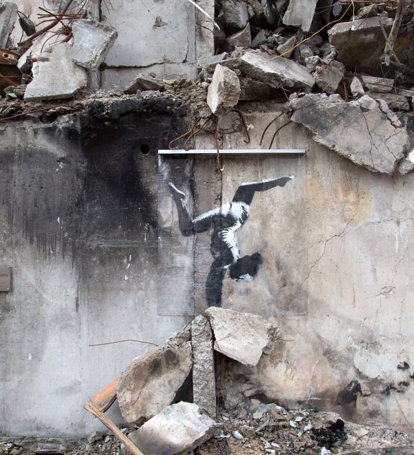 Graffiti art of a gymnast in rubble