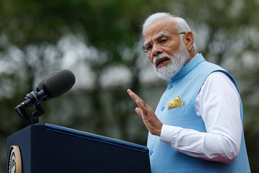 A photo of Narendra Modi speaking at a podium.