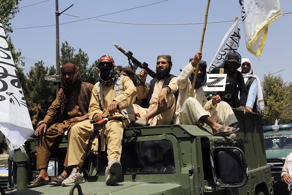 Taliban fighters celebrate the third anniversary of the withdrawal of US-led troops from Afghanistan, in Kabul, Afghanistan, Wednesday, Aug. 14, 2024. (AP Photo/Siddiqullah Alizai)