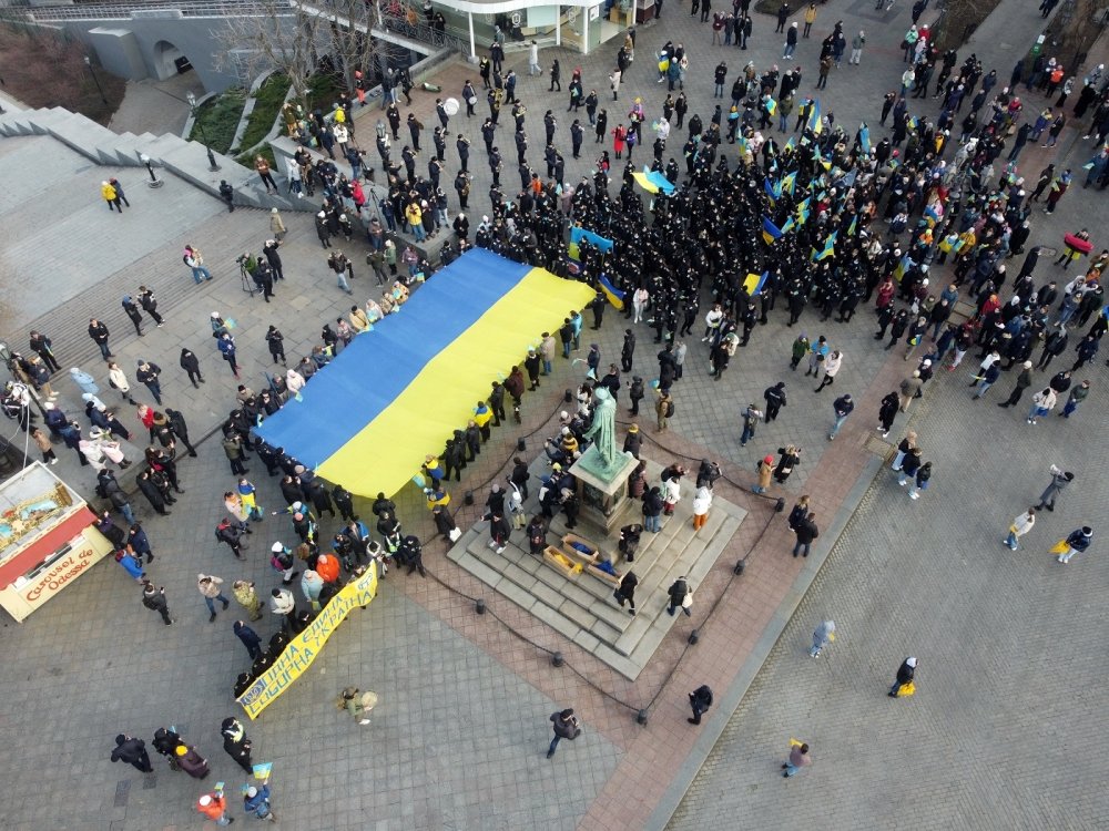 Odessa, Ukraine February,16,2022 Unity Day of Ukraine People carry a huge flag of Ukraine and Belarus near the monument to Duke de Richelieu . Taken from a drone.