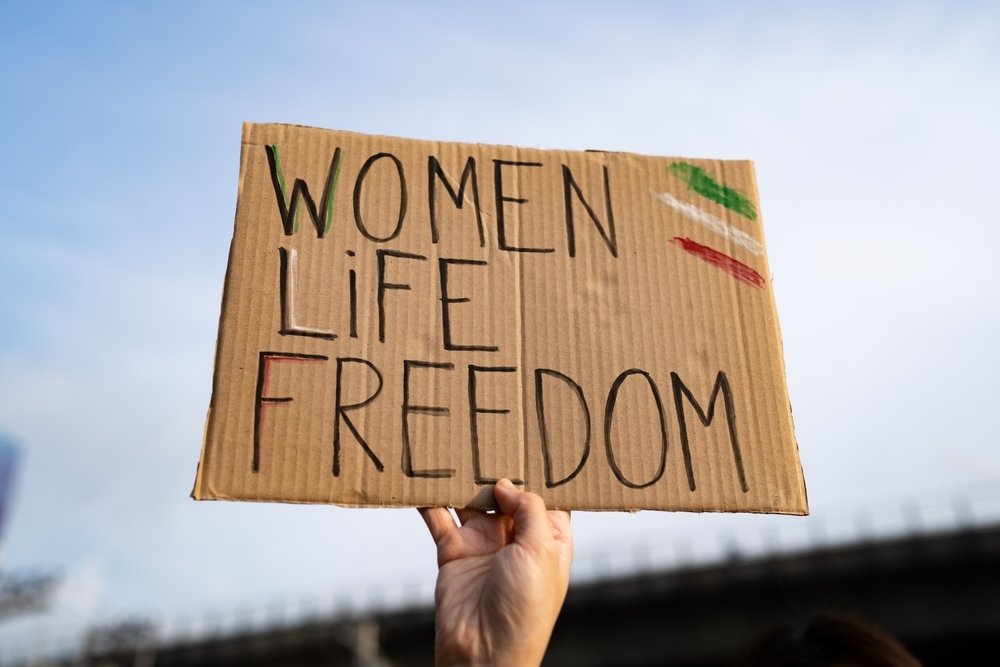 Protest sign reading "Women, Life, Freedom"