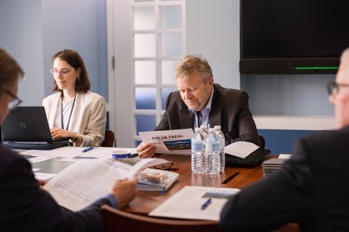 Photo of people reading a newsletter