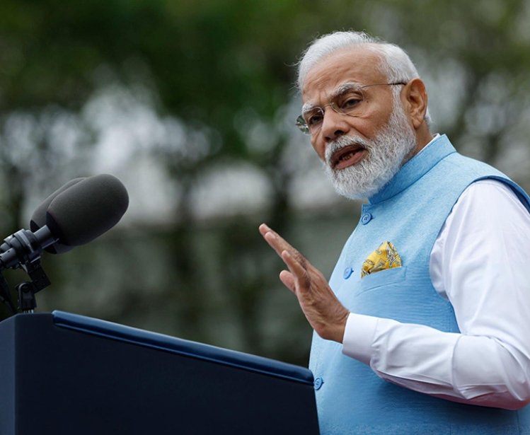 A photo of Narendra Modi speaking at a podium.