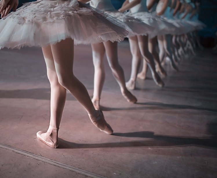 Dancers in white tutus performing swan lake