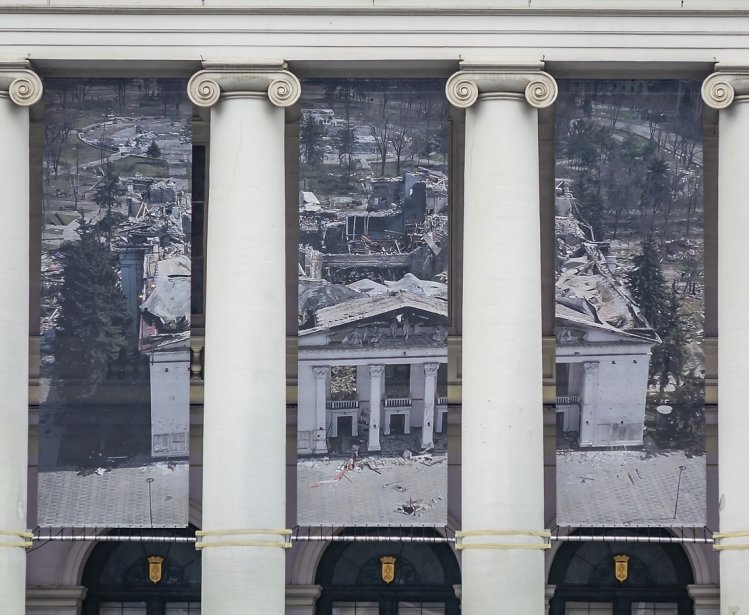 Theater facade, banner showing destroyed Mariupol Theater