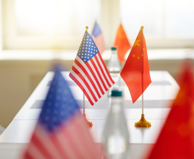 US and Chinese Flags Across a Table