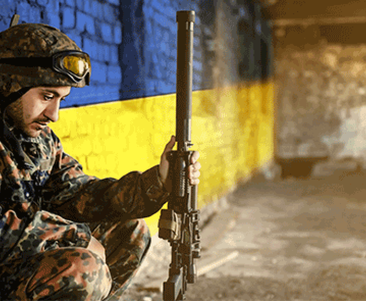 Soldier in front of Ukraine Flag