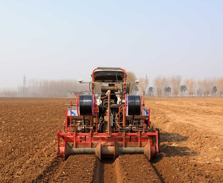 Farmer driving agricultural machinery