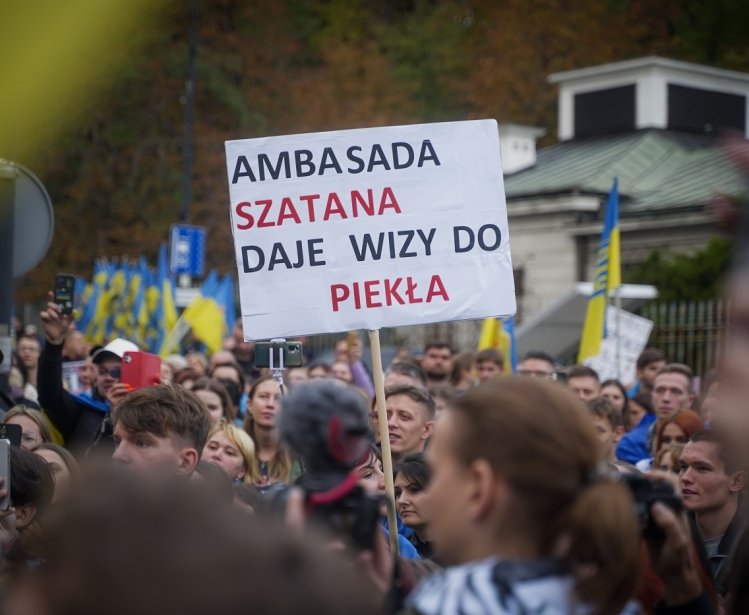 A man in Warsaw, Poland holds a sign protesting the Russian invasion of Ukraine