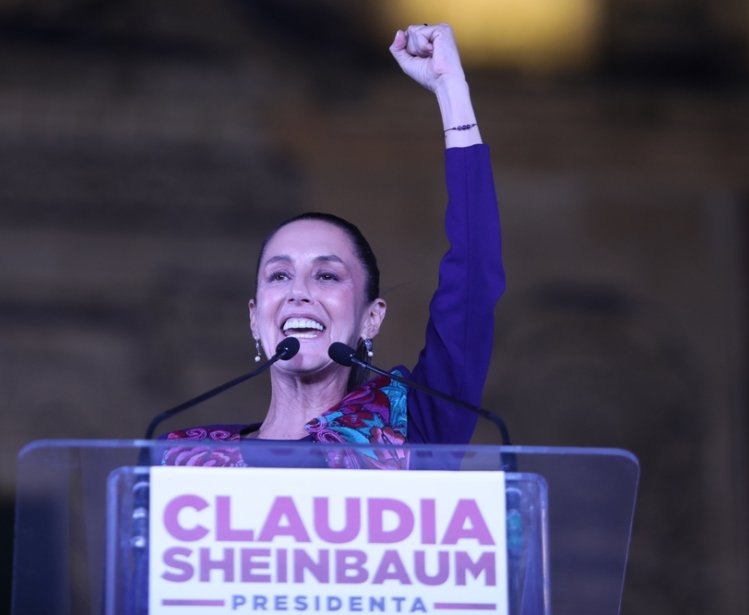 Claudia Sheinbaum with arm raised