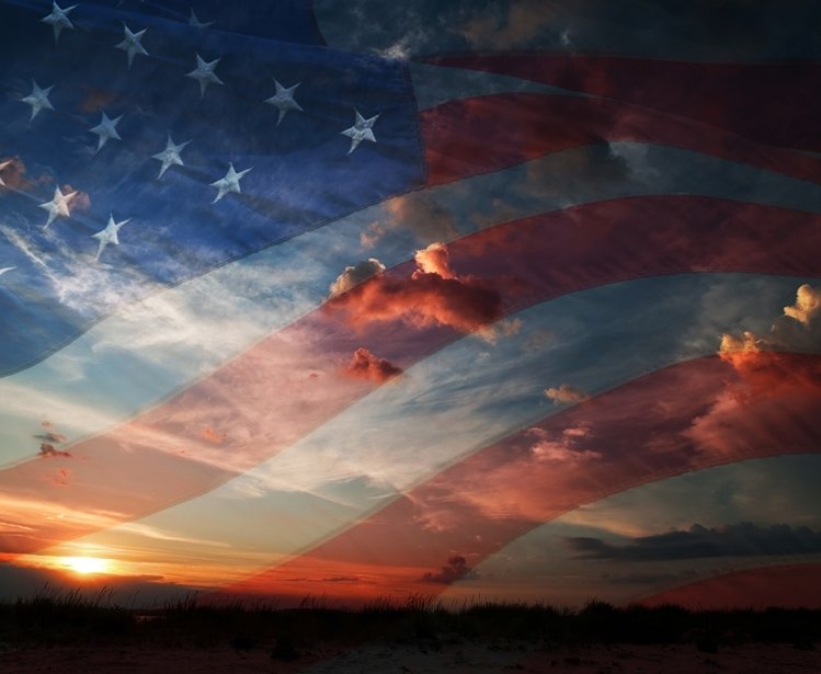 American flag against clouds