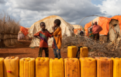 Children standing in line to fill water and yellow drums in Baidoa, Somalia, 2019.  Shutterstock