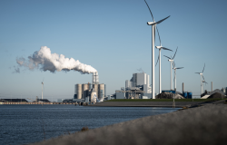 Wind turbines next to coal power station