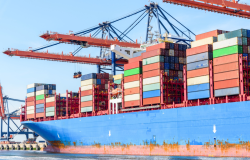 Crane loads shipping containers onto a ship