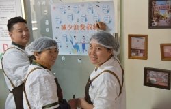 Three kitchen employees playing a game to reduce food waste