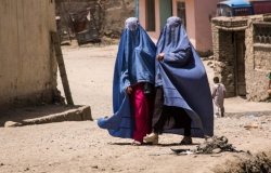 Afghan women in burqas walking in the street in Kabul, timsimages.uk/Shutterstock.com; End War in Afghanistan protest from local diaspora in Ottowa, Canada.