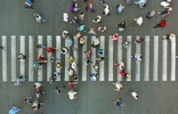 Aerial view of pedestrians passing a crosswalk during rush hour