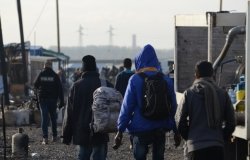  A group of migrants leave the Calais Jungle in Frane.