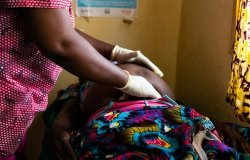 African woman doctor examining a pregnant patient