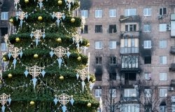 Christmas tree in front of ruined buildings in Ukraine