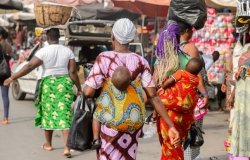 Little babies carried by their mothers at a market in West Africa.